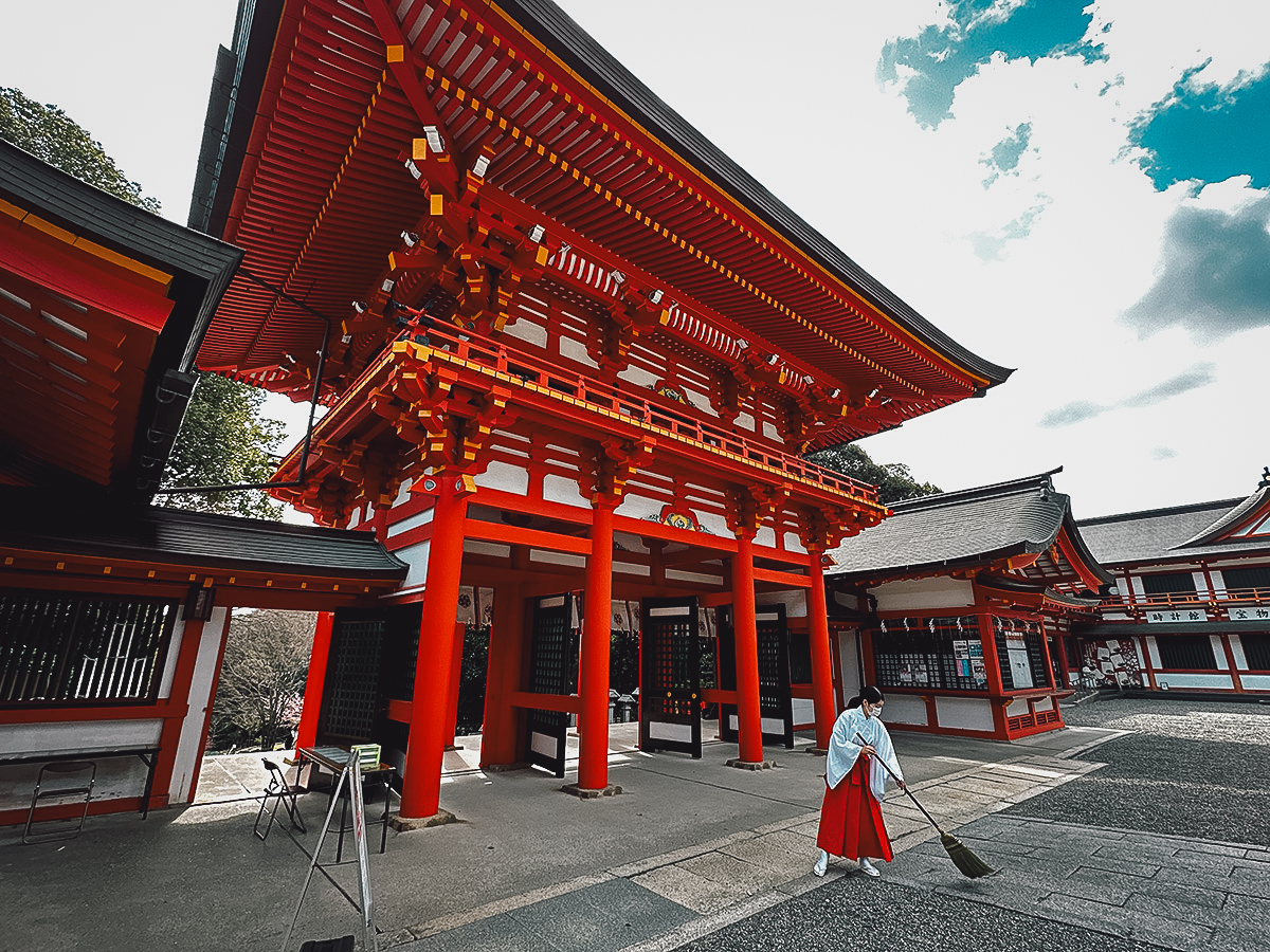 Lake Biwa Travel Guide Shrine maiden sweeping at Omi Jingu