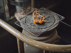 Dried squid grilling on a stove