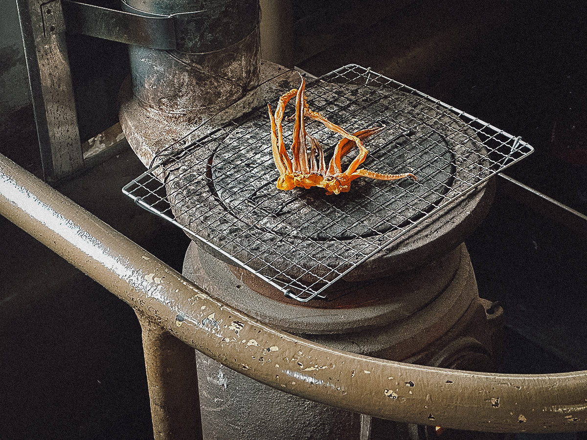 Dried squid grilling on a stove