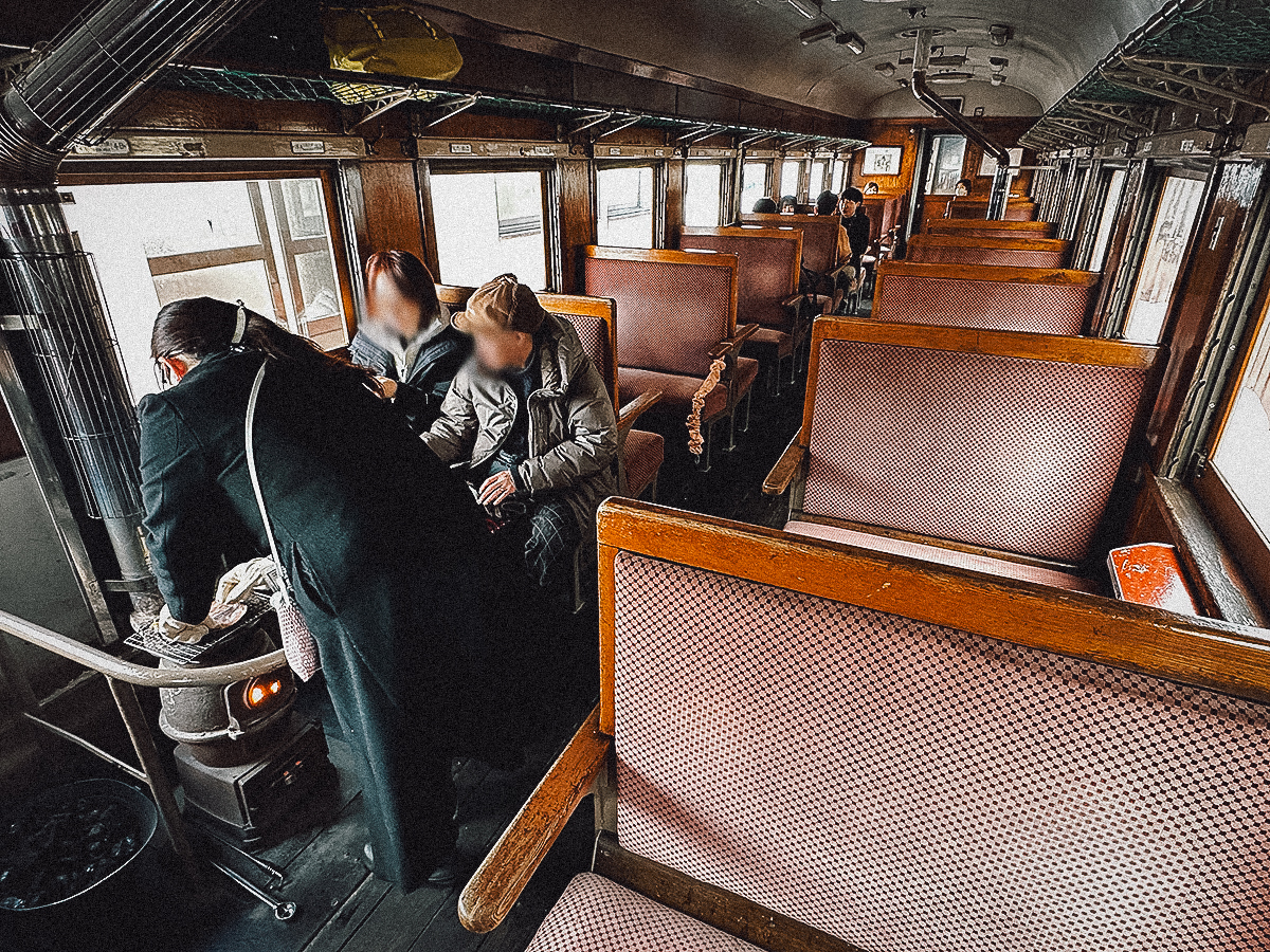 Railway employee grilling dried squid for passengers