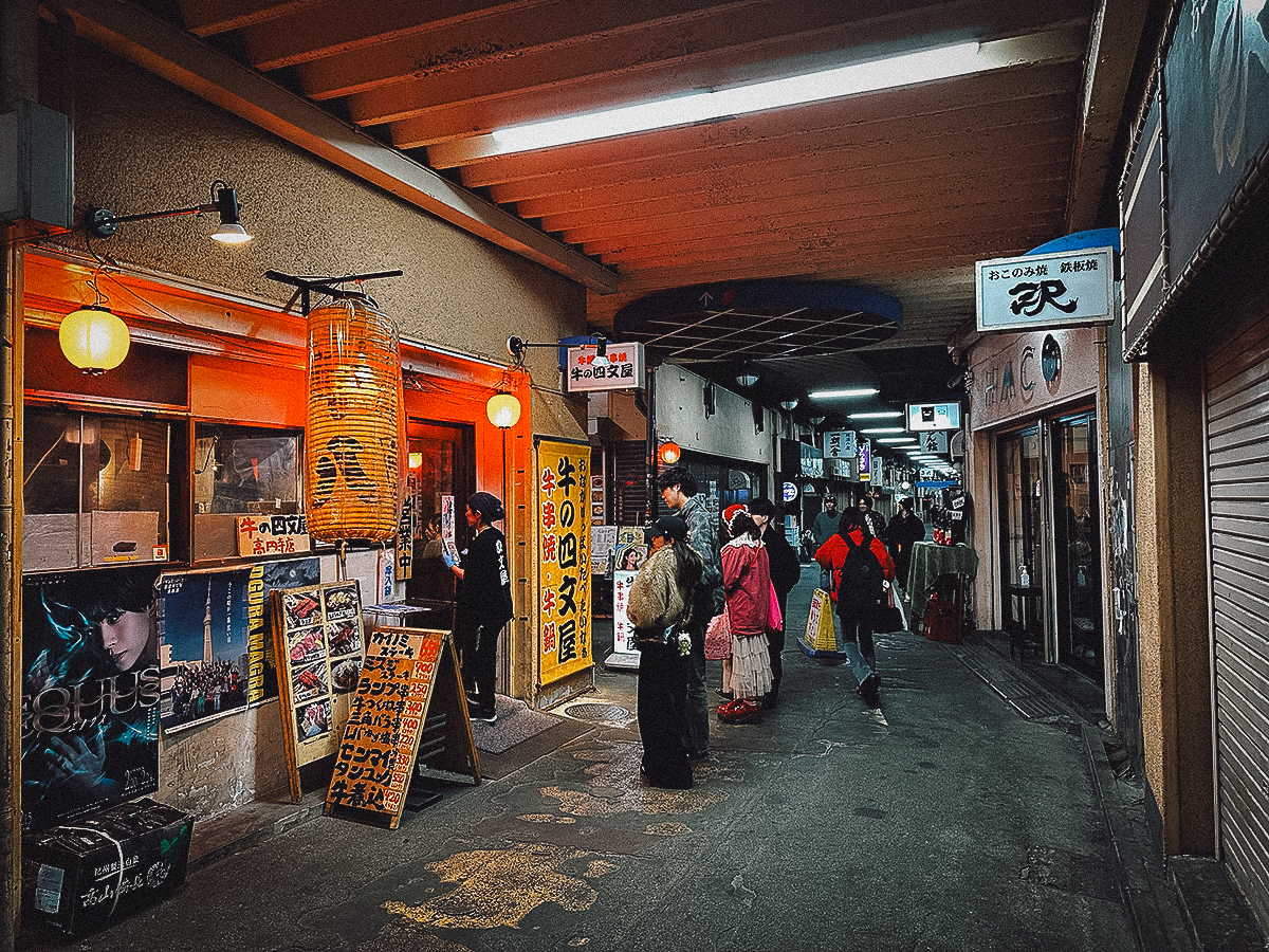 Line of customers waiting to enter an izakaya at Koenji Gado-shita