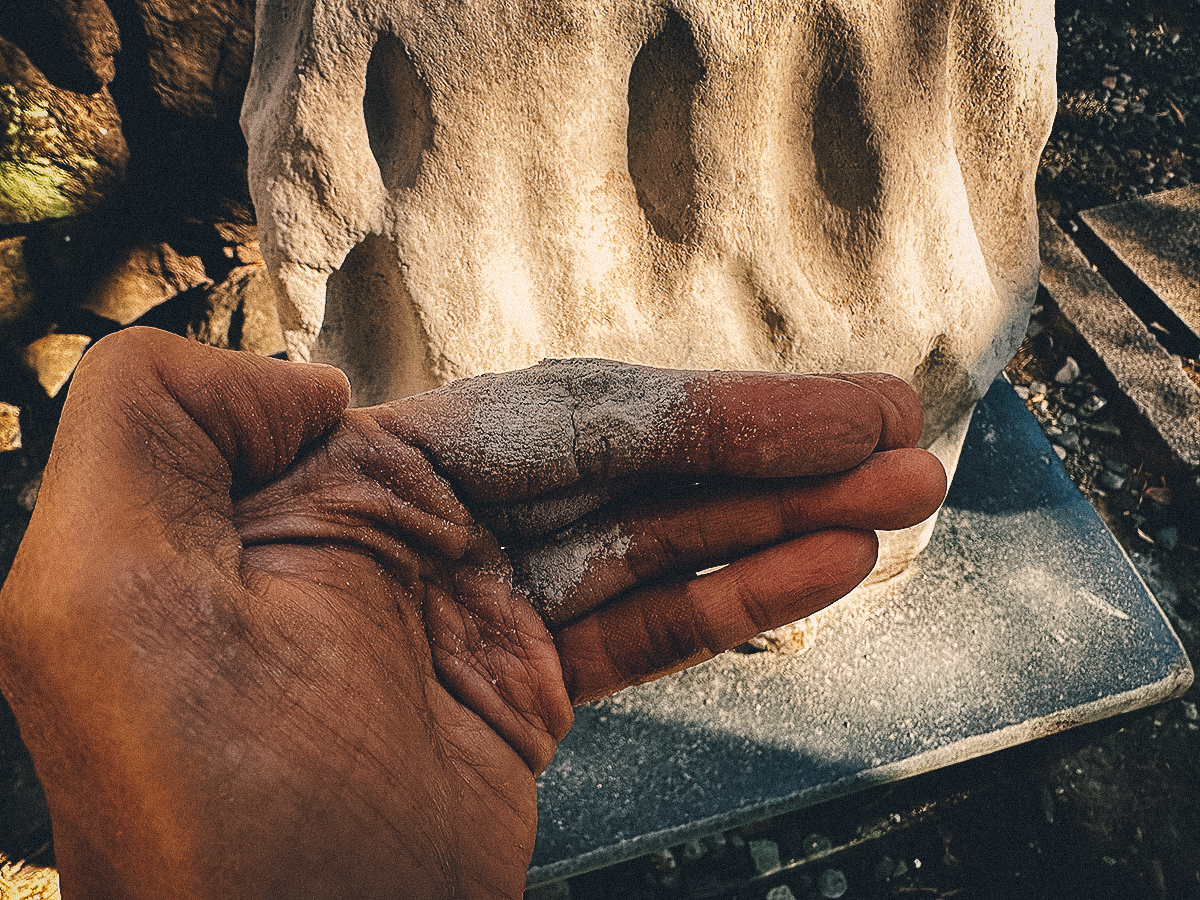 Stone dust on fingers