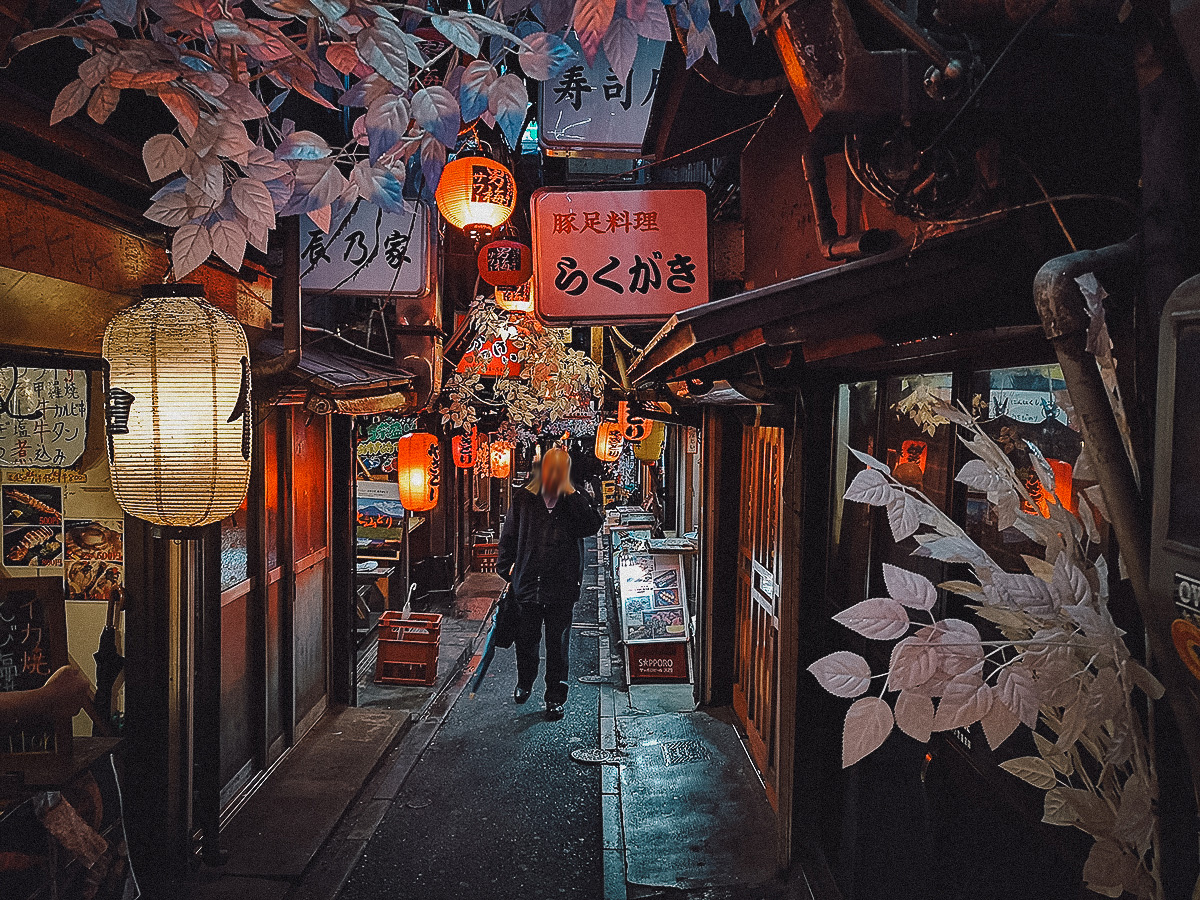 Japanese man walking through Omoide Yokocho